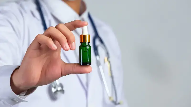 a doctor holding cbd tincture